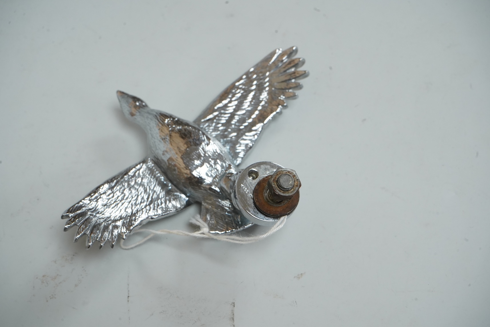 A Louis Lejeune cast chrome plated car mascot modelled as a bird in flight, wing span 12cm